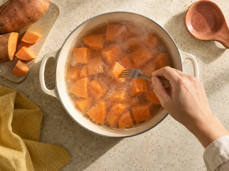 Sweet potato cubes simmering in a pot